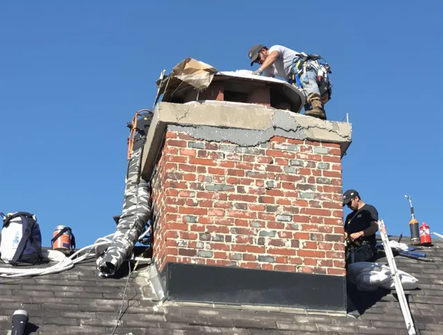Warrensville Heights Chimney Sweep installing a custom chimney crown in Warrensville Heights, OH