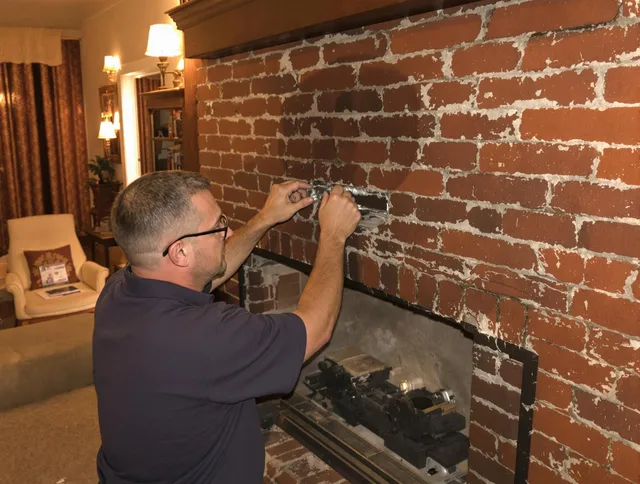 Warrensville Heights Chimney Sweep expert fixing a fireplace in Warrensville Heights, OH